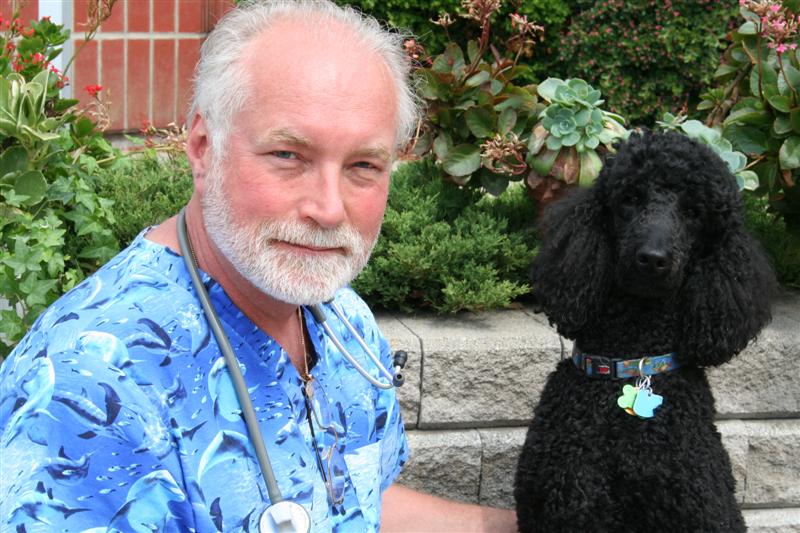 Team member Dr. Jim Sweetman with his black poodle